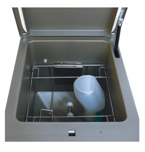 A compact bedpan washing featuring a plastic container, designed for efficient cleaning in small spaces.