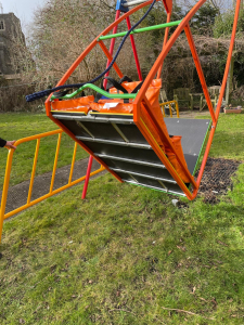 A swing with weight bags lying on it, indicating weight measurement.