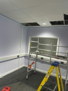 Engineers working on Molift ceiling hoist installation with ceiling track system